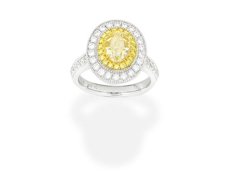 FANCY COLOURED DIAMOND AND DIAMOND RINGThe Fancy Yellow oval-cut diamond, weighing 1.50 carats, within surrounds of brilliant