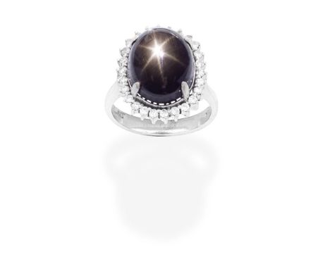 BLACK STAR SAPPHIRE AND DIAMOND CLUSTER RINGSet with a black cabochon star sapphire within an old brilliant-cut diamond surro