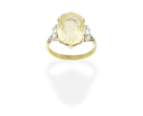 YELLOW SAPPHIRE AND DIAMOND RINGThe cushion-shaped yellow sapphire between brilliant-cut diamond-set shoulders, ring size app