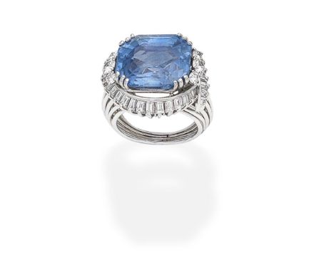 SAPPHIRE AND DIAMOND RING,  CIRCA 1950The octagonal step-cut sapphire, weighing 19.33 carats, between brilliant-cut diamond a