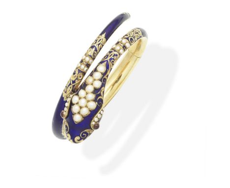 ENAMEL, HALF-PEARL AND GARNET SNAKE BANGLE, CIRCA 1860Designed as a coiled serpent, decorated with blue enamel, the head and 
