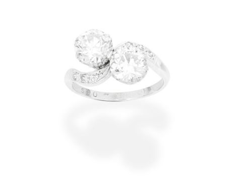 DIAMOND TWO-STONE RINGOf crossover design, set with two old brilliant-cut diamonds between single-cut diamond shoulders,  pri