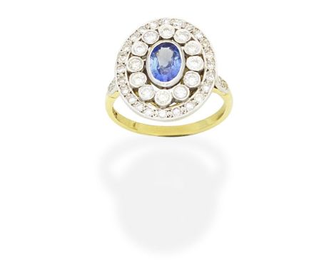 SAPPHIRE AND DIAMOND CLUSTER RINGThe oval-cut sapphire within a surround of brilliant and single-cut diamonds, diamonds appro