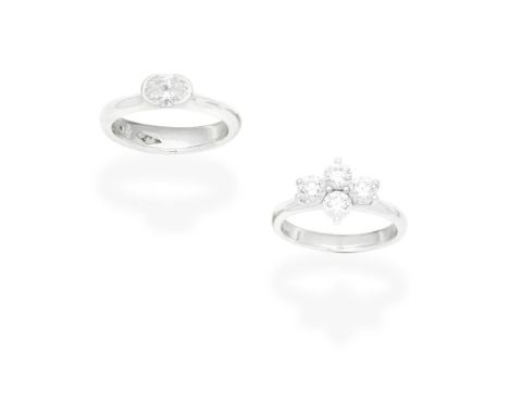 TWO DIAMOND RINGS1st: Set with an oval-cut diamond, 2nd: Set with a quatrefoil of brilliant-cut diamonds, mounted in platinum