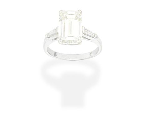 DIAMOND RINGSet with an emerald-cut diamond, weighing 4.82 carats, between tapered baguettes, ring size very approx. KFor fur