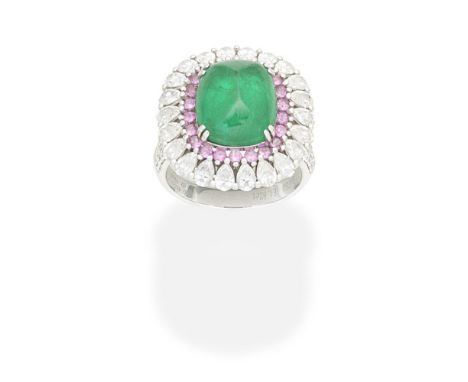 EMERALD, RUBY AND DIAMOND DRESS RINGThe sugarloaf emerald cabochon within a surround of circular-cut rubies and pear-shaped d