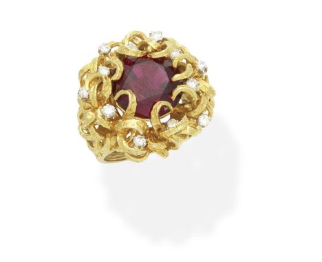 GARNET AND DIAMOND DRESS RINGThe circular-cut garnet within a textured ribbon mount, with brilliant-cut diamond accents.   di