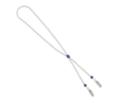 LAPIS LAZULI AND DIAMOND LAVALLIÉREThe lapis lazuli cabochon set between trios of brilliant-cut diamonds, suspending two lapi