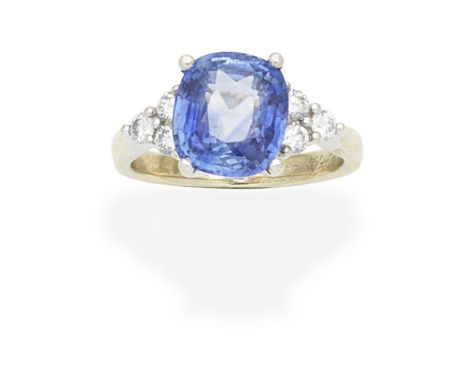 SAPPHIRE AND DIAMOND RINGThe cushion-cut sapphire, weighing 4.86 carats, between  brilliant-cut diamond-set shoulders diamond