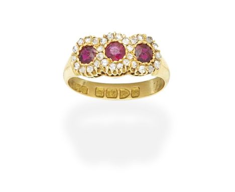RUBY AND DIAMOND CLUSTER RING, 1910Set with three circular-cut rubies within rose-cut diamond surrounds, inner hoop inscribed