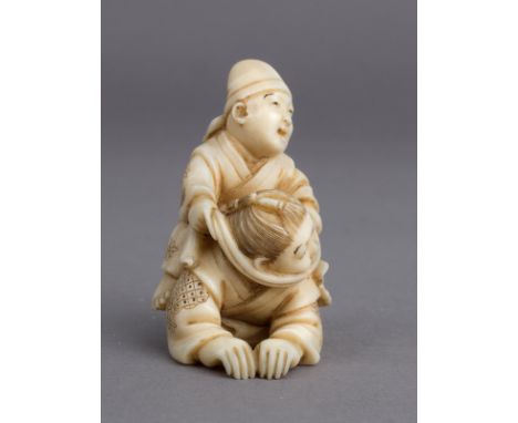 A 19th century Japanese netsuke from Meiji period. Signed Mitsuyoshi on the base. In carved elephant ivory portraying a pair 