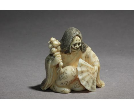 A late 19th century netsuke karakuri from Meiji period. Signed Saigetsu on the base. In carved elephant tusk portraying Okame