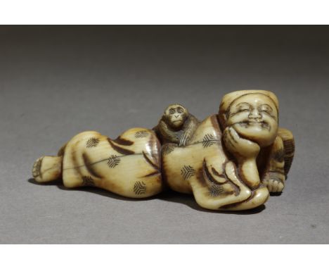 A Japanese netsuke from Edo period circa 1800. Not signed. In carved elephant tusk portraying Sarumawashi lying on the floor 