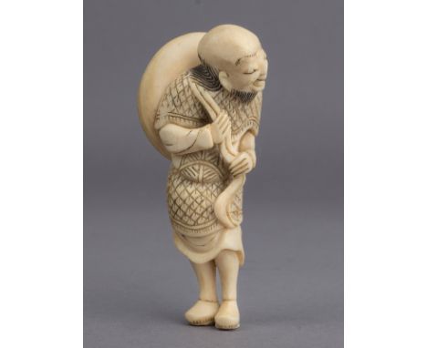 A mid 18th century Japanese netsuke from Edo period. Not signed. In carved elephant ivory portraying a standing Sennin grabbi