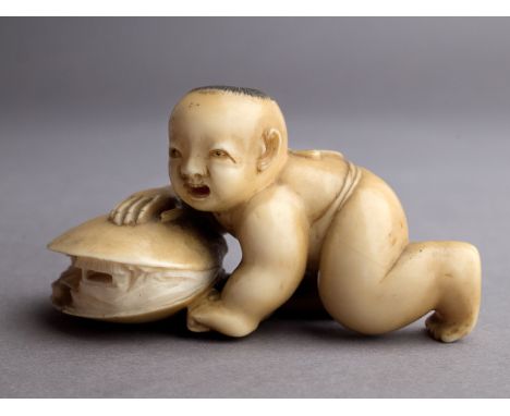 A 19th century Japanese netsuke from Meiji period. Not signed. In carved elephant ivory portraying a karako crawling over a s