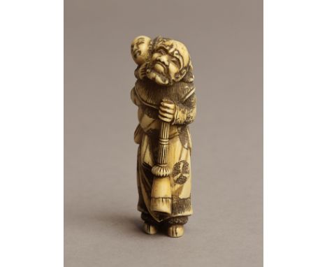 A 19th century Japanese netsuke from Edo period. Signed on the back. In carved elephant ivory portraying an elder carrying a 