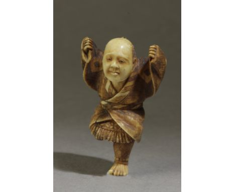 A late 19th century Japanese netsuke from Meiji period. Not signed. In carved elephant tusk portraying a warrior jumping on o