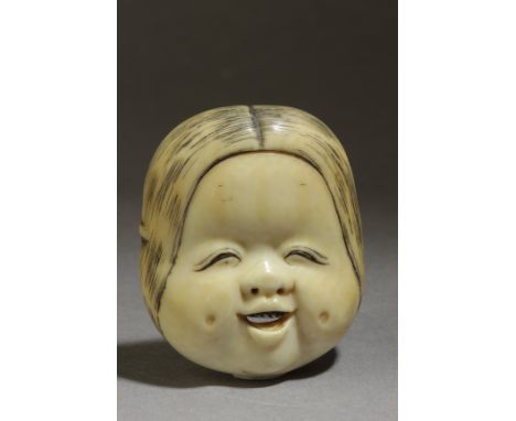 A Japanese netsuke from Meiji period circa 1900. Signed on the back. In carved elephant tusk portraying a smiling Okame mask,