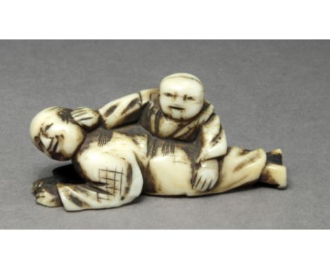 A 19th century Japanese netsuke from Edo period. Signed on the base. In carved ivory portraying a group of figurines composed