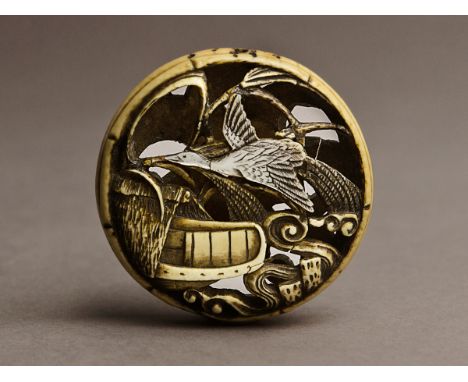 A 19th century Japanese netsuke manju from Meiji period. Not signed. In carved elephant ivory portraying a goose flying over 