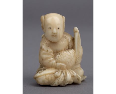 A 19th century Japanese netsuke from Meiji period. Not signed. In carved elephant ivory portraying a kneeling karako who is h