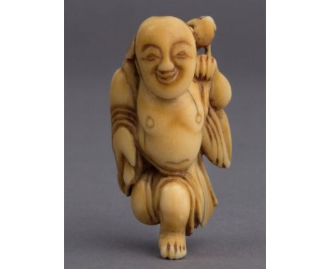 A 19th century Japanese netsuke. Not signed. In carved elephant ivory portraying Gama Sennin who is carrying a toad over his 