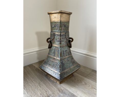 Chinese polished bronze pear shaped vase of hexagonal section with loose ring handles, decorated with Champlevé enamel bands 