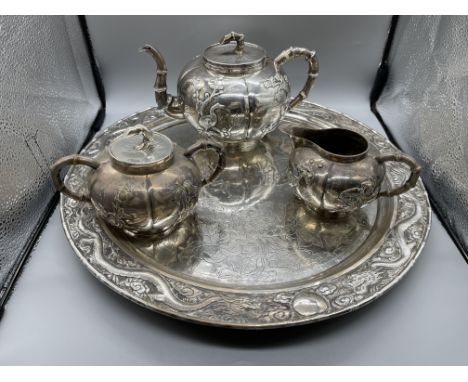 19th Century Chinese Four Piece Silver Tea Service. Tray 38cm in circumference, Teapot H12cm x W20cm, Sugar Pot H9cm x W15cm,