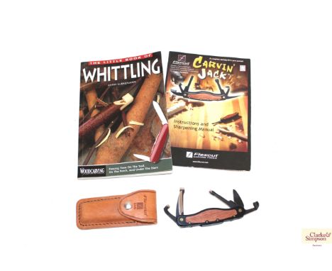 A Flexcut "Carvin Jack" folding carving tool with pouch, manual and a book on whittling