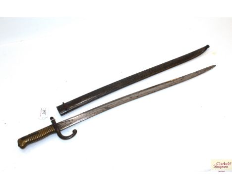 A French model 1866 brass hilted sabre bayonet dated 1868 with scabbard