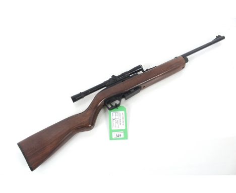 A Crosman model 1077 Repeater CO2 .177 Cal. air rifle, with wooden stock and a B.S.A. 4x20 scope fitted.NB. As a post 1939 ai