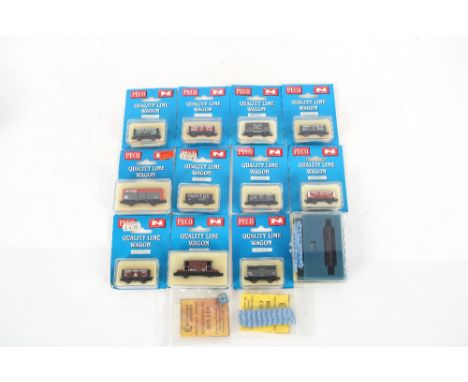 Eleven Peco British N Gauge Quality Line wagons (boxed); and an N scale rail cleaner