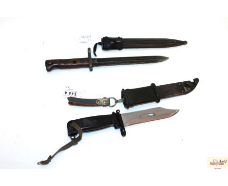 An A.K.M. bayonet with scabbard and an AF Italian example