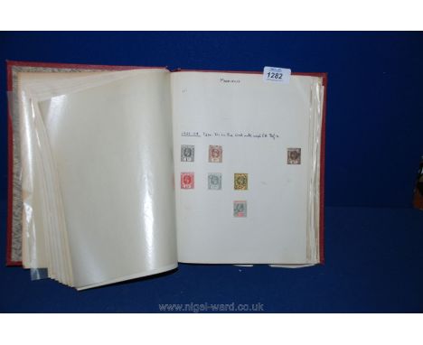 A red Sussex Stamp Album of British empire and Commonwealth stamps from Queen Victoria to QEII.