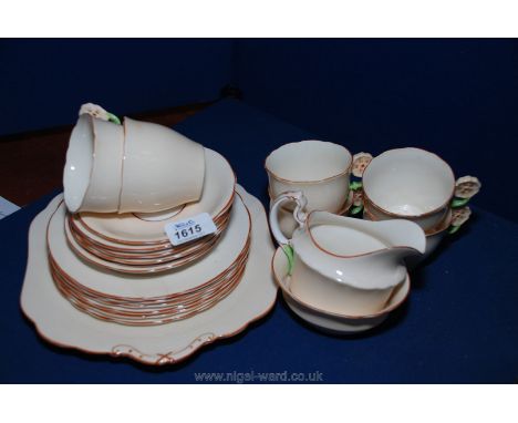 An Aynsley Teaset in light peach ground with embossed floral decorated handles, six place setting, (one teaplated a/f)