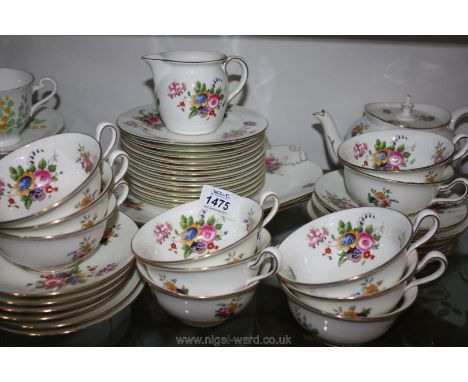 A bone china tea service in floral pattern with butterflies including twelve each tea plates, saucers, eleven teacups, two br