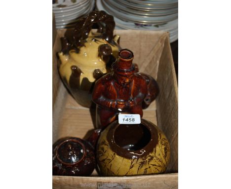 A collection of treacle glazed items including a Puzzle Jug, two small teapots, vase and a spirit decanter of a hated gent