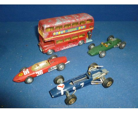 Three Corgi toys Racing Cars including a Lotus-Climax Formula 1 in British Racing Green; Ferrari Formula 1 (No. 154) in red; 