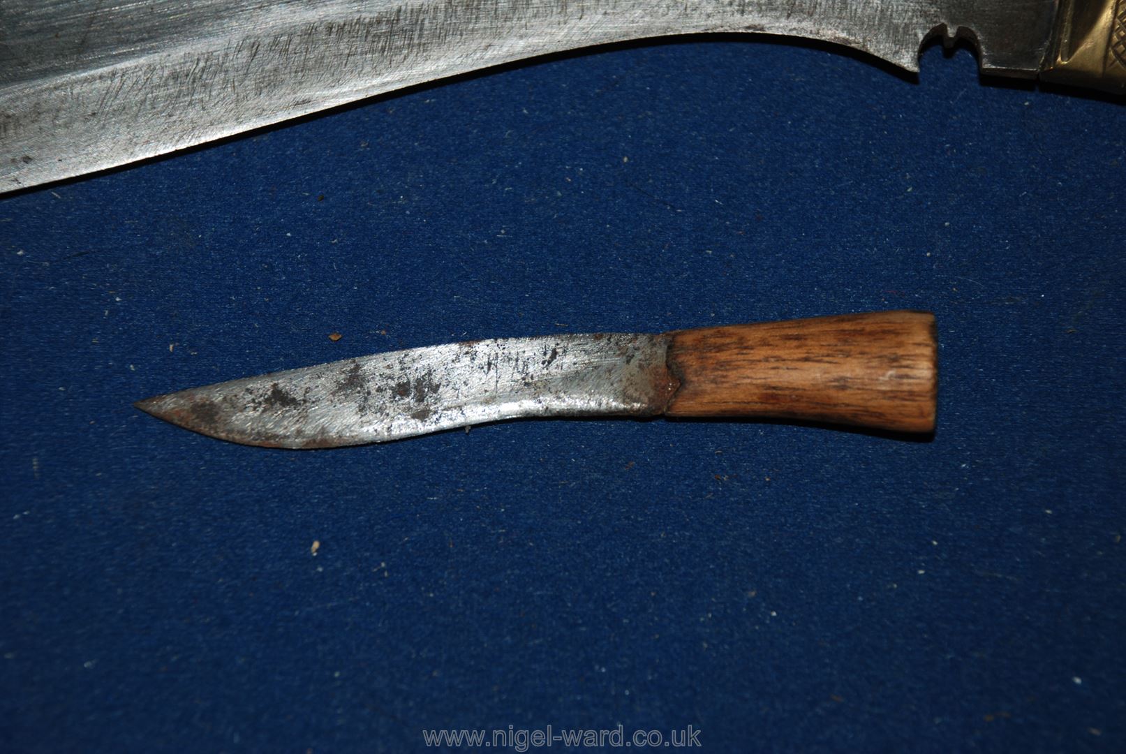 Two curved Knives possibly Chinese in leather sheath, one 13" long, the