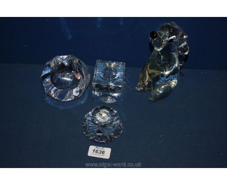 An Orrefors glass tea light holder, Edinburgh crystal paperweight, crystal dog ornament and a cube paperweight.