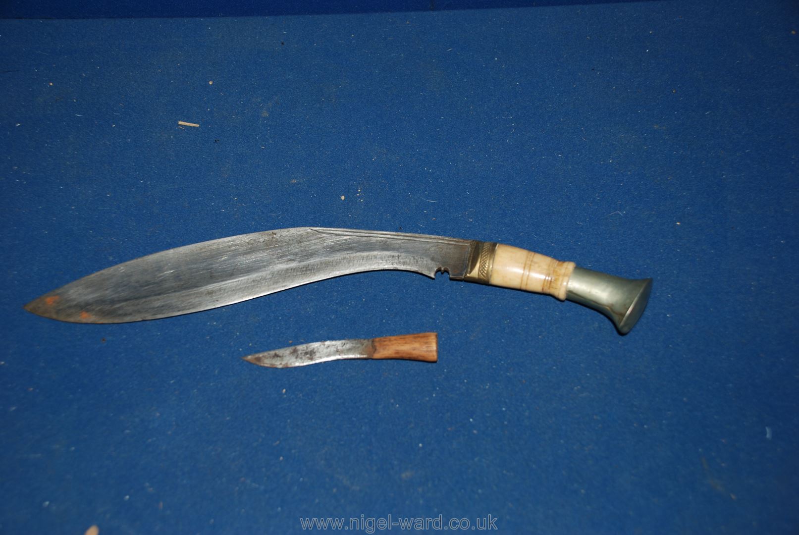 Two curved Knives possibly Chinese in leather sheath, one 13" long, the