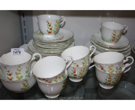 A Radfords bone china Tea Service with hollyhock design including twelve tea plates, ten saucers, eight cups (one with hairli
