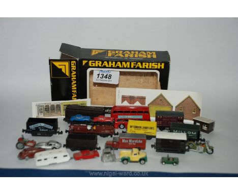 A Graham Farish box containing "N" gauge Peco, Trix and G.F. rolling stock incl. 4 open trucks, goods van, guards van, hopper