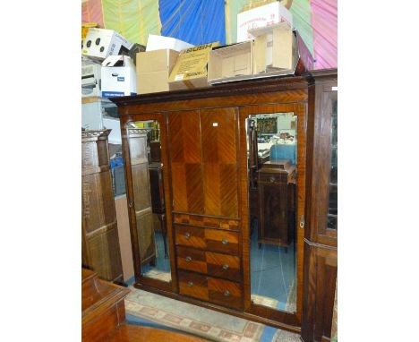 An Edwardian Mahogany Compactum Wardrobe with cornice over full length bevel plated mirrored door to each end, with pair of c