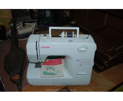 A Singer Electric Sewing Machine and manual