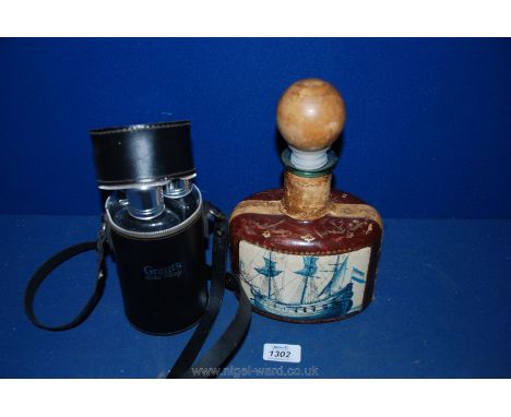 A Grant's Scotch Whiskey triple glass Flask set in a carrying case and a leather bound oval shaped Decanter with wooden knob 