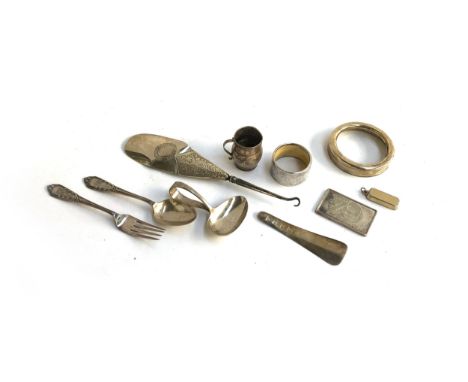 A small lot of silver to include a 20th century caddy spoon, Birmingham 1921; a christening spoon and fork; small silver shoe