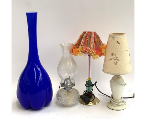 A tall blue glass vase with lobed base, 50cmH, together with an oil lamp and two table lamps 