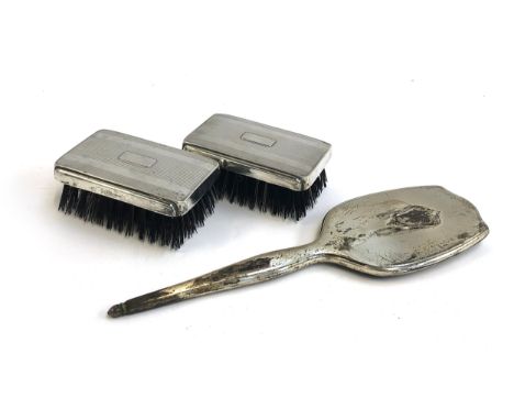 A pair of stiff bristles clothes brushes, the white metal backs marked Sterling; together with a silver toasting/pickle fork 
