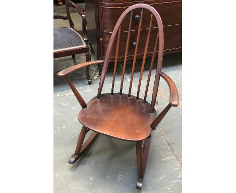 An Ercol elm child's stickback rocking chair 
